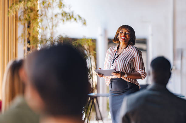 istock Confident Speaker Leading Business Workshop in Modern Office 2174029729