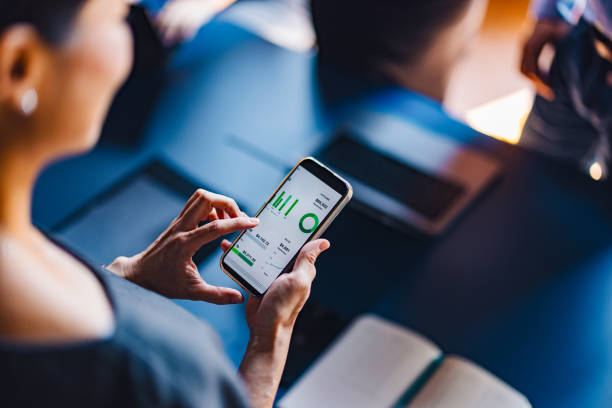 Businesswoman Analyzing Data on Smartphone in Office