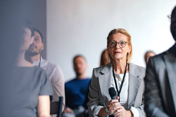 istock Businesswoman Speaking at Conference with Diverse Audience 2174029747