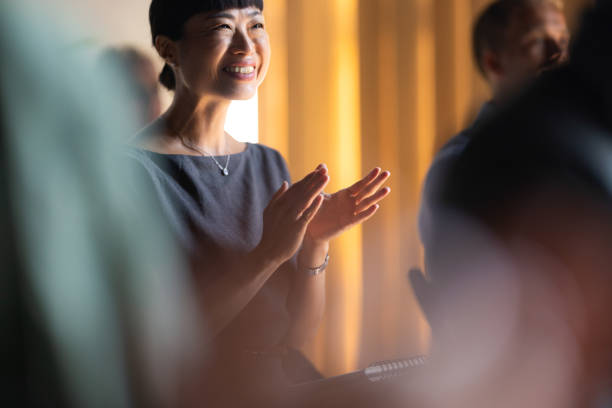 istock Smiling Woman Clapping at Business Event 2174029780