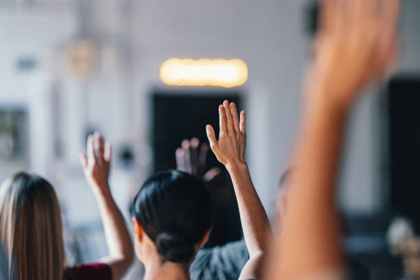 istock People Raising Hands at Business Event for Participation 2174029818