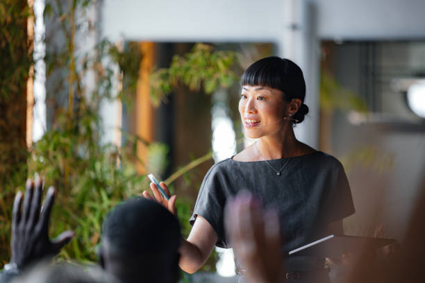 istock Confident Presenter Leading Business Seminar with Engaging Speech 2174029853