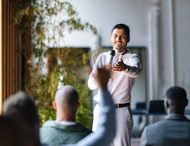 istock Business Speaker Engaging with Audience During Event Presentation 2174029861