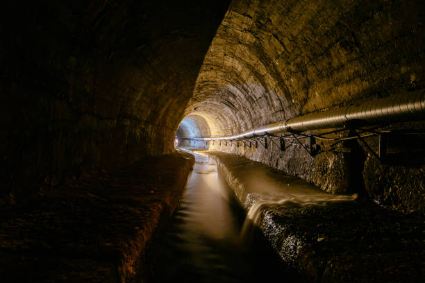 istock Underground vaulted urban sewer tunnel with dirty sewage 2174032077