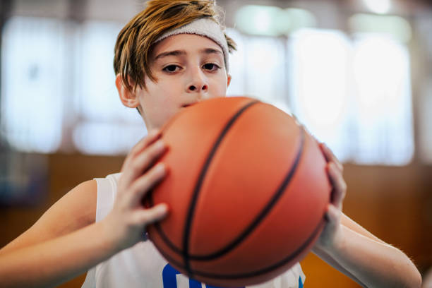 istock Kid playing basketball doing a shot 2174040436