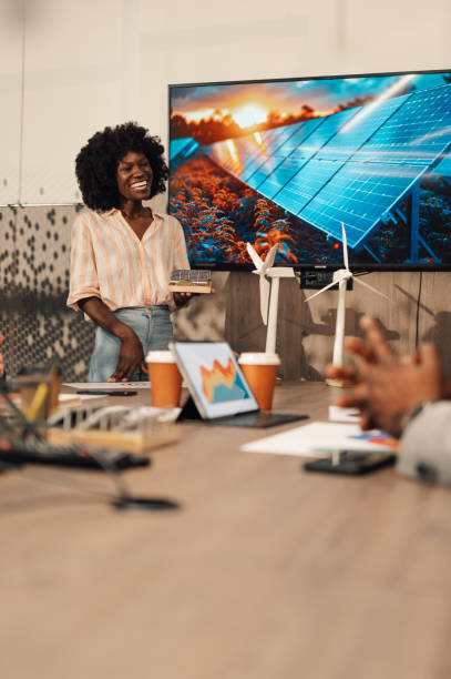 istock Interracial smiling expert with solar panel talking about renewable energy 2174040472