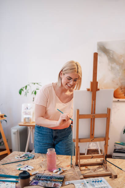 istock Talented painter painting on canvas and creating artwork at atelier. 2174040474
