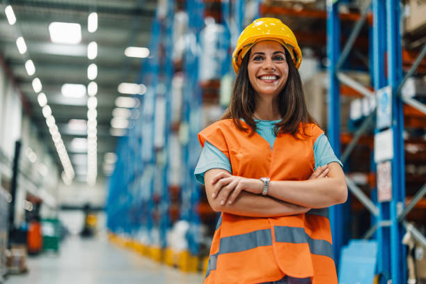 istock Confident female worker in warehouse arms crossed, smiling bright. 2174042631