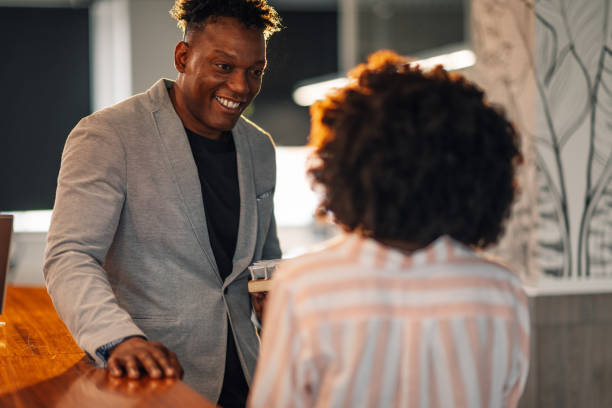 istock Smiling diverse colleagues with solar panels discussing sustainability 2174042744