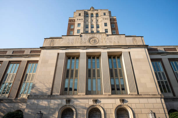 New York, NY USA - April 5, 2022 : People walking in front of the steps and columns of Low Library illuminated in the blue and yellow colors of the Ukrainian flag at dusk at Columbia University in Morningside Heights, New York City, USA