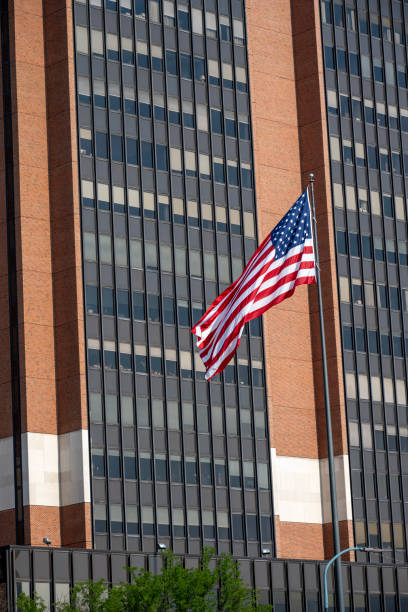 istock American flag in front of building 2174046895