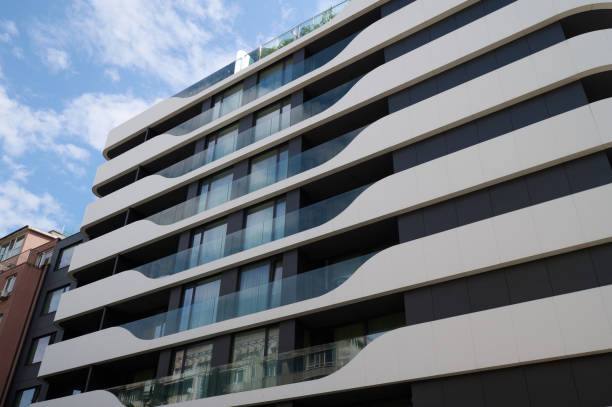 Modern residential building showcasing wavy architectural design against a bright blue sky, Varna, Bulgaria