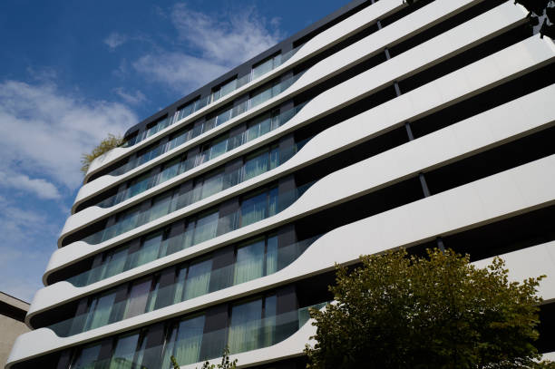 istock Modern architectural design featuring flowing lines in a residential building under a clear blue sky. Varna, Bulgaria 2174048848