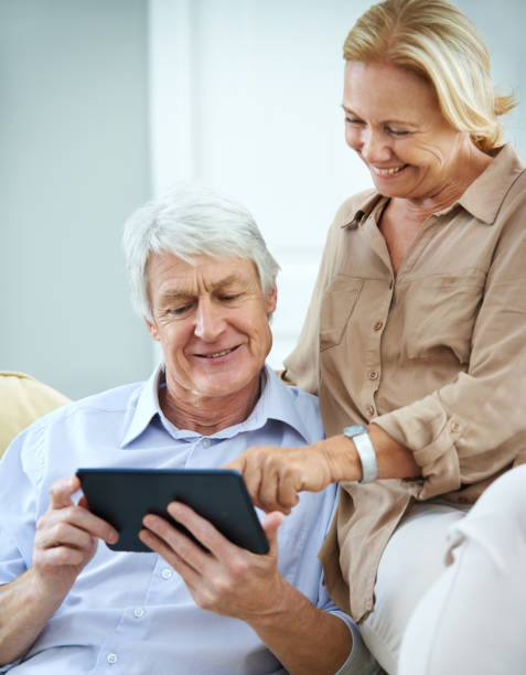 istock Home, tablet and old couple with conversation, help or retirement with online reading. Apartment, mature man or senior woman with tech, network or digital app for communication, advice or discussion 2174053424