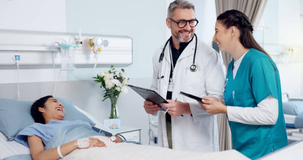 istock Patient, doctors, and tablet in hospital, teamwork and help with joke, laughing and connection. Clinic, nurse or medical with professional, tech or internet with humor, healthcare or treatment result 2174053841