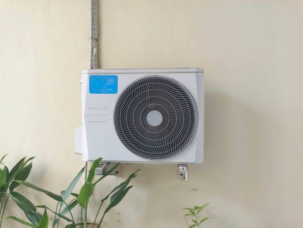 istock Outdoor split wall type air conditioner compressor unit inverter installed on the orange wall. White air conditioner compressor installed out of building cause to be exposed to the sun and rain. 2174057166
