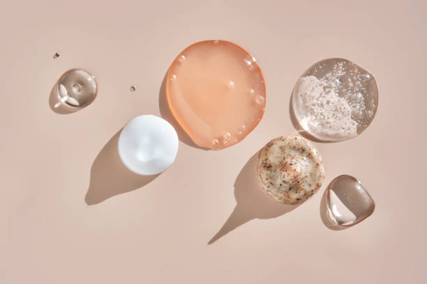 Several cosmetic products on a pink background.