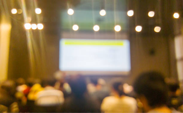 Blurred background people join seminar business event in auditorium hall convention.  Presentation meeting at conference room present screen business. Blurred background with copy space