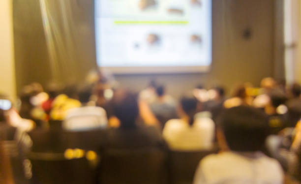 istock Blurred background people join seminar business event in auditorium hall convention.  Presentation meeting at conference room present screen business. Blurred background with copy space 2174066303