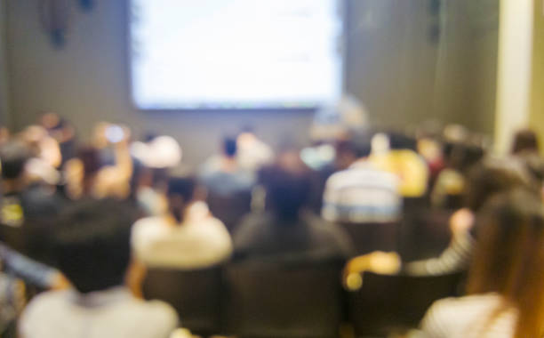 istock Blurred background people join seminar business event in auditorium hall convention.  Presentation meeting at conference room present screen business. Blurred background with copy space 2174066309
