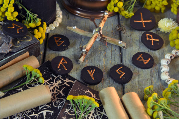 istock Mystic still life with old scrolls, black runes and witchy ritual objects on wooden altar table. Occult, esoteric, wicca, Halloween and gothic concept. 2174072801