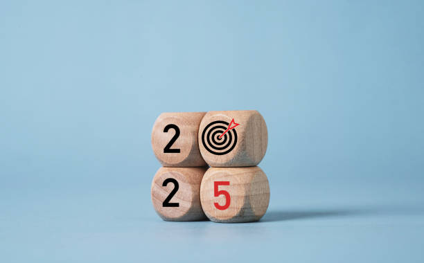 istock 2025 with dartboard arrow print screen on wooden block cube for setup business setup objective  target and goal when change to new year concept. 2174073443