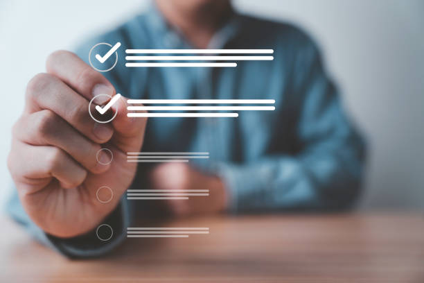 istock Businessman use pen to tick correct sign mark in checkbox for quality document control checklist and business approve project concept. 2174074842