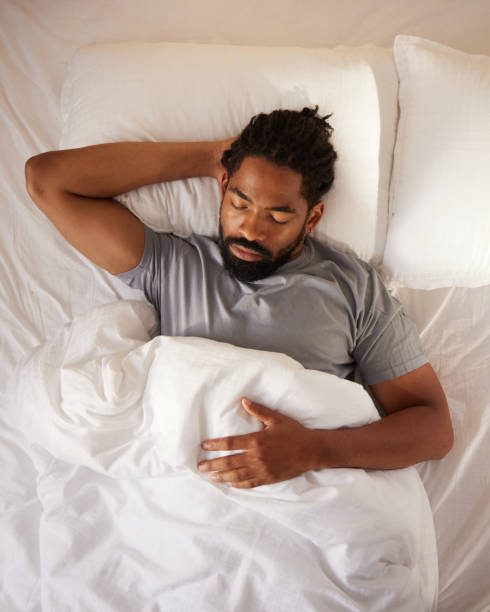 istock Above view of black man sleeping in bed. 2174077673