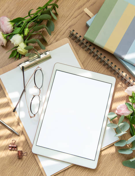 istock A cozy workspace setup featuring a tablet, stationery, and fresh flowers in soft natural light for inspiration and creativity 2174080168