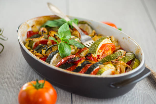 istock prepared baked zucchini and tomatoes in circles in a ceramic form, vegetable snack 2174081763