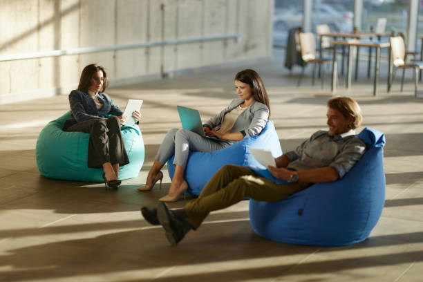 istock Business colleagues working on computers and paperwork at casual office. 2174082593
