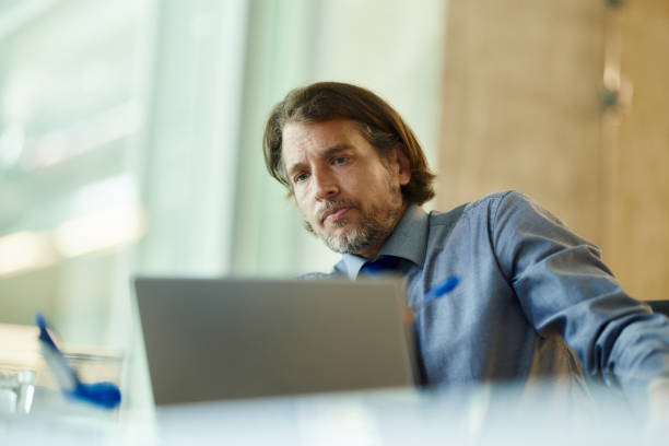 istock Serious businessman working on a computer in the office. 2174082963