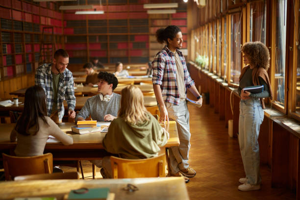 istock Large group of college students learning in library. 2174084353