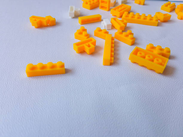 istock Colorful Plastic Yellow Toy Bricks Background 2174084850