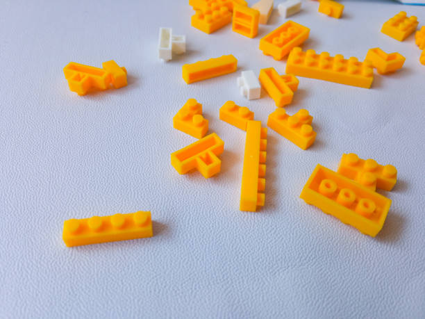 istock Colorful Plastic Yellow Toy Bricks Background 2174084882