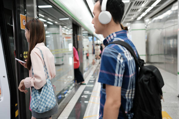 Asians enter subway cars from the platform