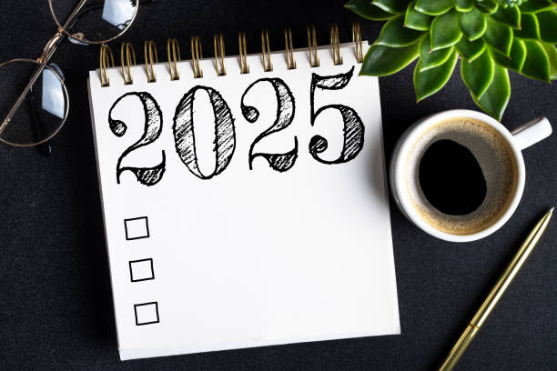 istock 2025 New year resolutions on desk. 2025 goals list with notebook, coffee cup, plant on black table. Resolutions, plan, goals, action, checklist, idea concept. New Year 2025 resolutions 2174085949