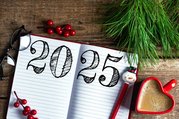 istock New year resolutions 2025 on desk. 2025 resolutions list with notebook, coffee cup on wooden table. Goals, resolutions, plan, action, checklist concept. New Year 2025 template 2174086143