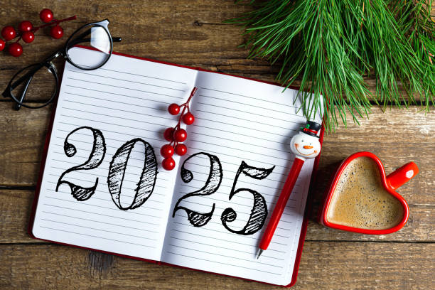 istock New year resolutions 2025 on desk. 2025 resolutions list with notebook, coffee cup on wooden table. Goals, resolutions, plan, action, checklist concept. New Year 2025 template 2174086250
