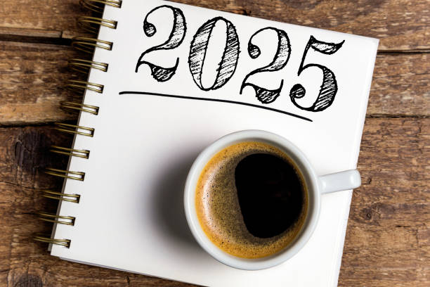 istock New year resolutions 2025 on desk. 2025 resolutions list with notebook, coffee cup on table. Goals, resolutions, plan, action, checklist concept. New Year 2025 template 2174086314