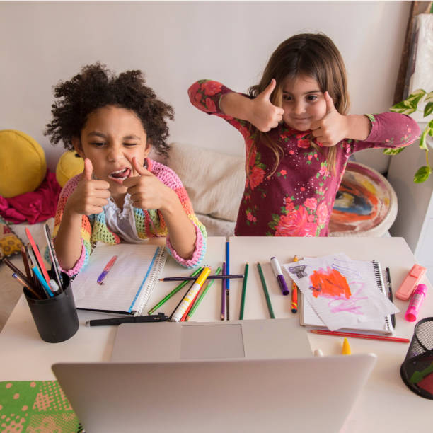 Two children joyfully engaging in a creative arts and crafts session at home during a sunny afternoon