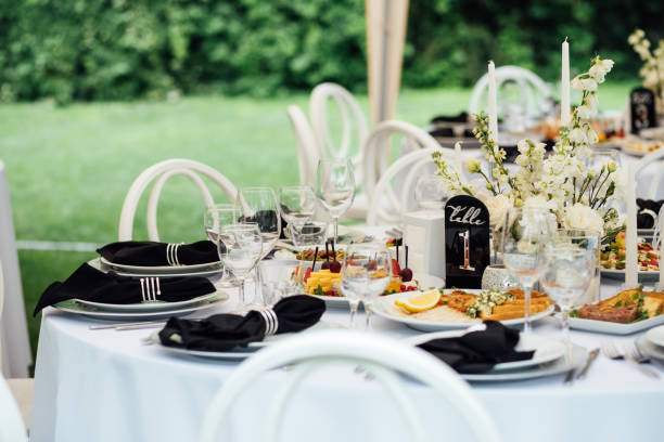 istock Luxurious restaurant. Luxurious interior, white tables, serving dishes and glasses for guests 2174087940