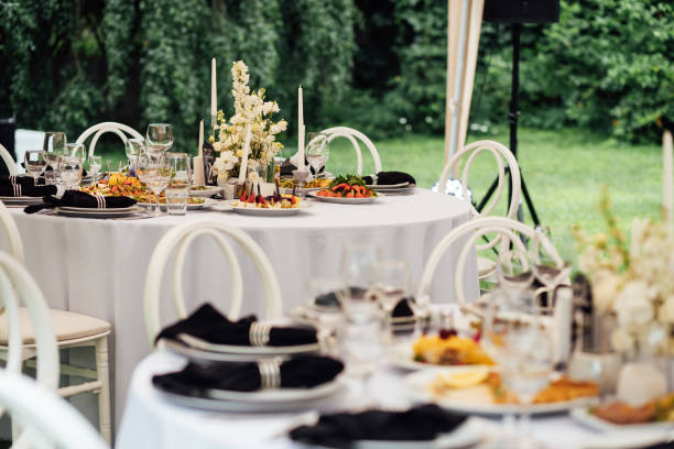 Luxurious restaurant. Luxurious interior, white tables, serving dishes and glasses for guests