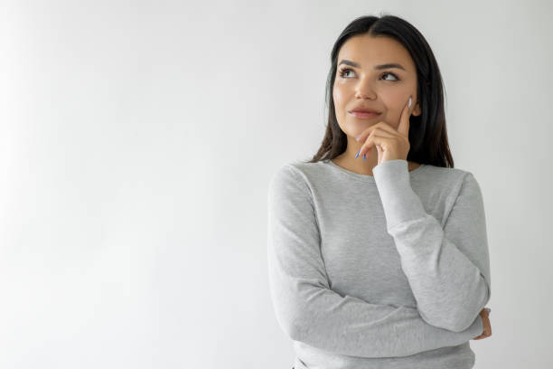 Thoughtful woman with hand on cheek