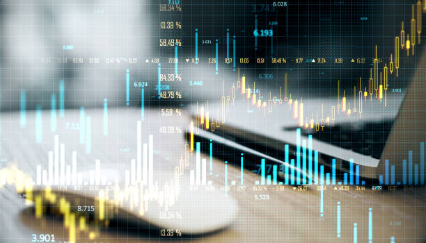 istock Double exposure of financial data charts over a laptop in an office setting. 2174090422