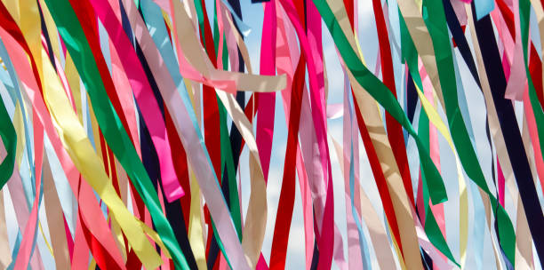 istock Multicolored festival ribbons flutter in the wind. Background 2174090580