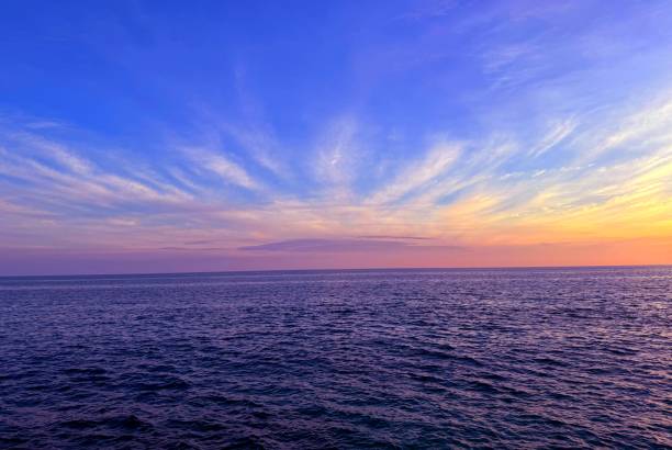 istock Dusk  heaven clouds over dark blue ocean waters. 2174093039