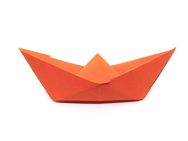 istock One orange paper ship with white background. 2174095989