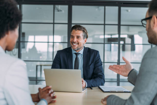 istock Group of business persons talking in the office. 2174096108