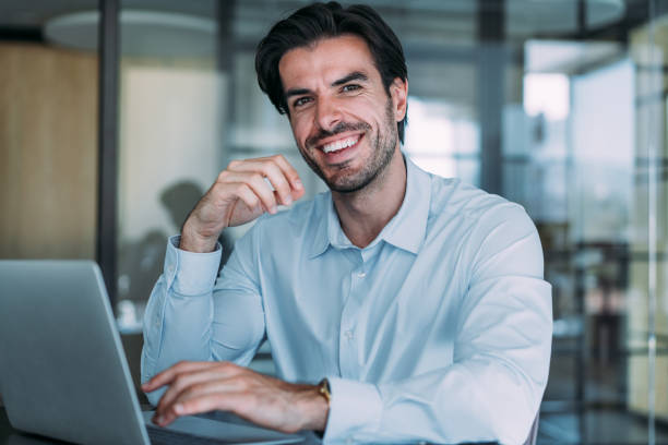 istock Successful businessman in modern office working on laptop. 2174096138